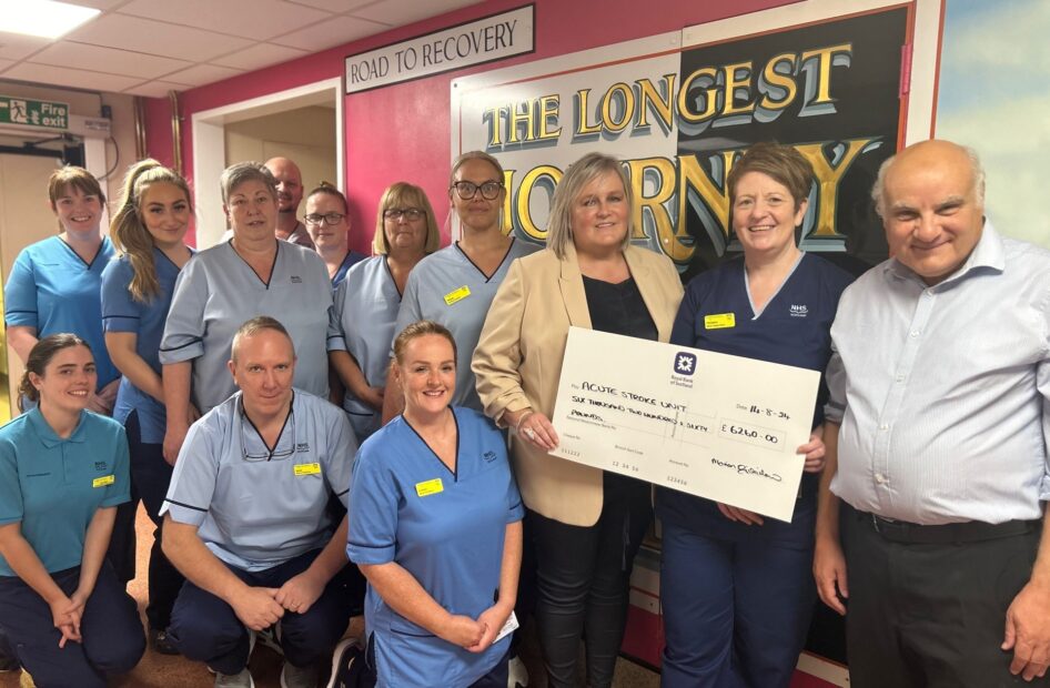 Marion presents the cheque to staff from the Acute Stroke Unit.