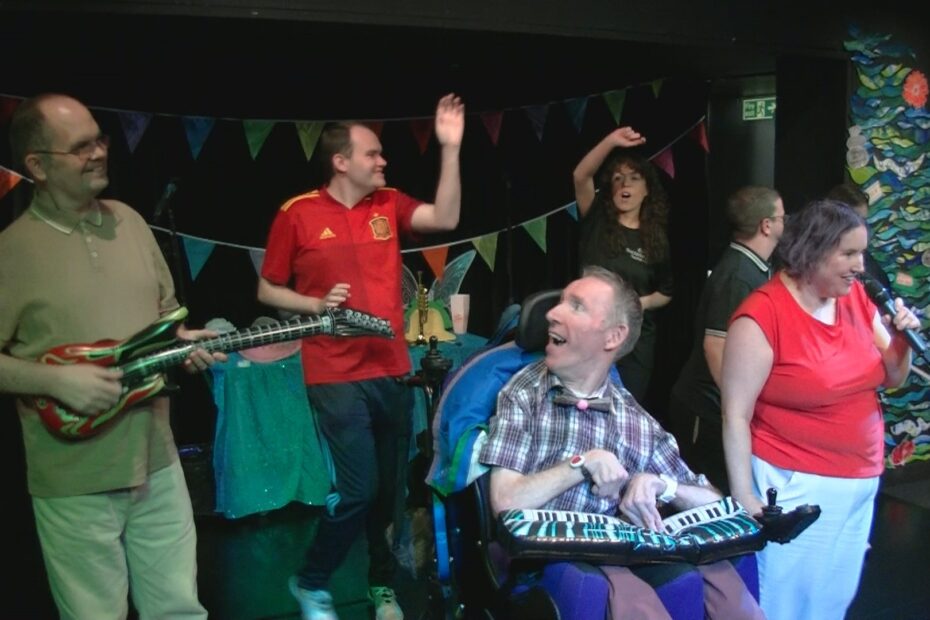 Image with a group of Trindlemoss clients having fun singing and dancing.