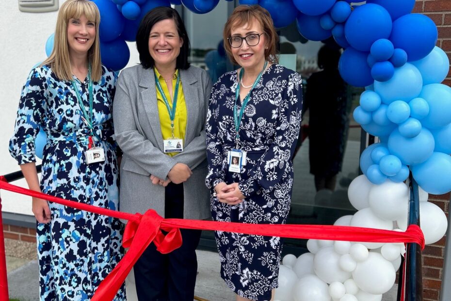 Julie Barret, Caroline Cameron and Thelma Bowers pictured standing in front of the new Mental Health Assessment Hub under a blue balloon arch for the official opening.