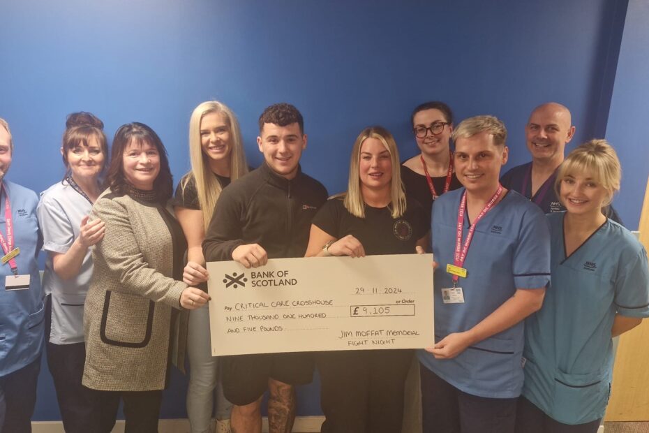 ICU staff pictured receiving a cheque from the family of Mr Moffat