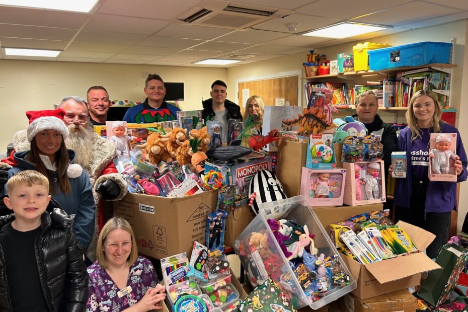 Group standing in front of donated toys