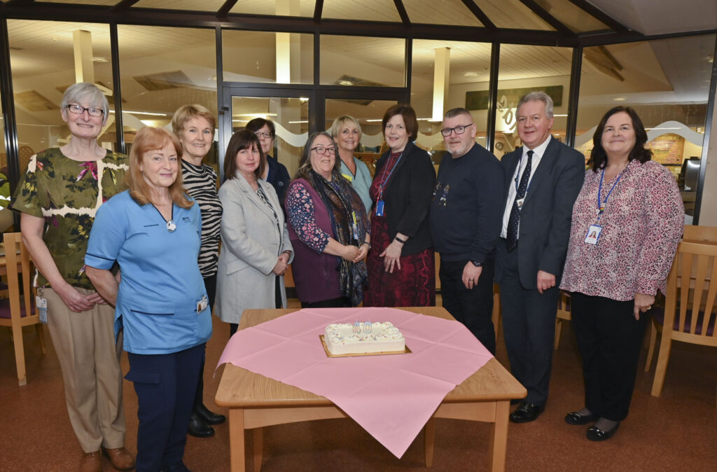 Staff from Ayr being presented with 40 years' service pin.