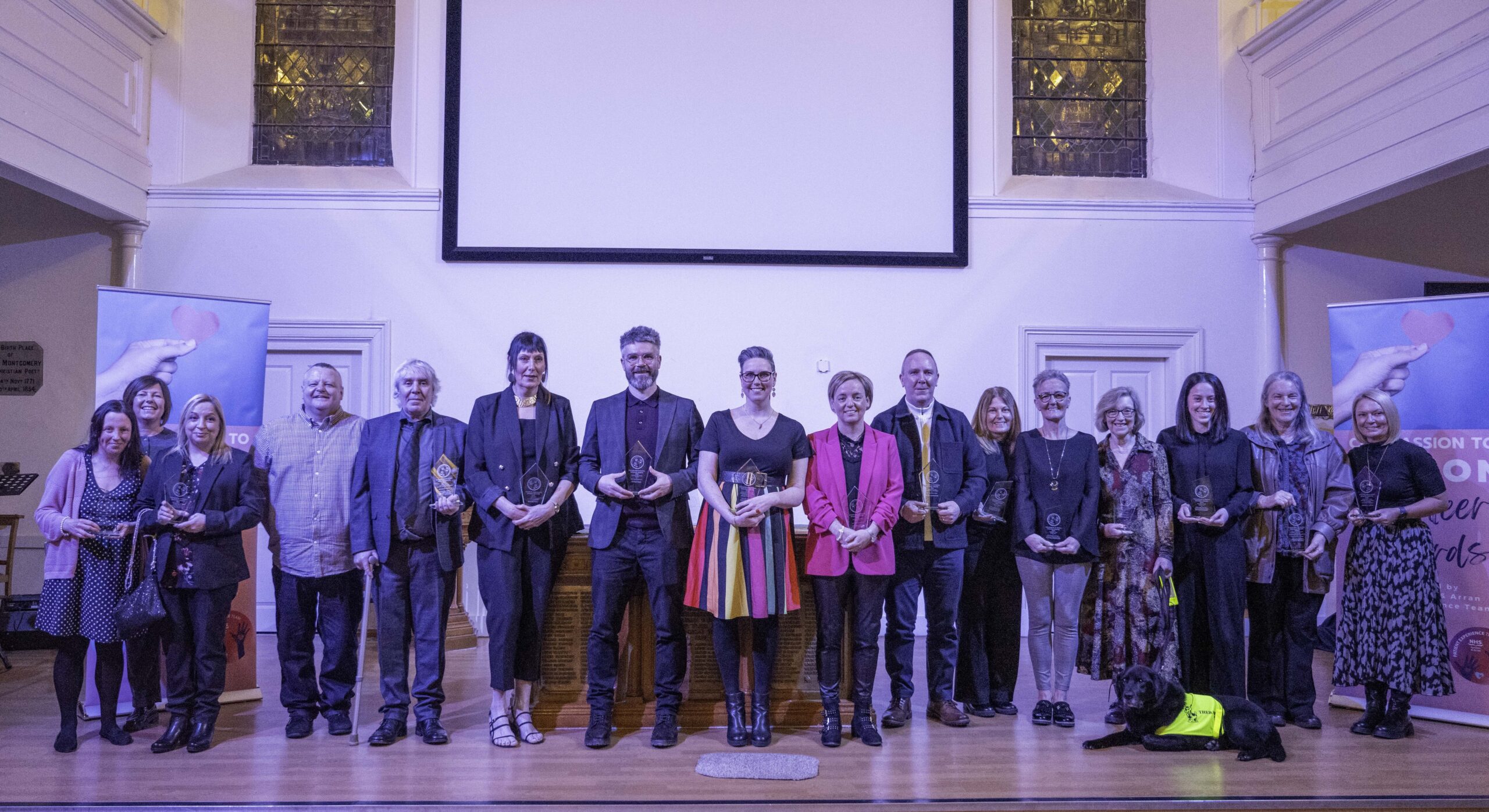 Winners of each of the Compassion to Action Awards standing on stage.