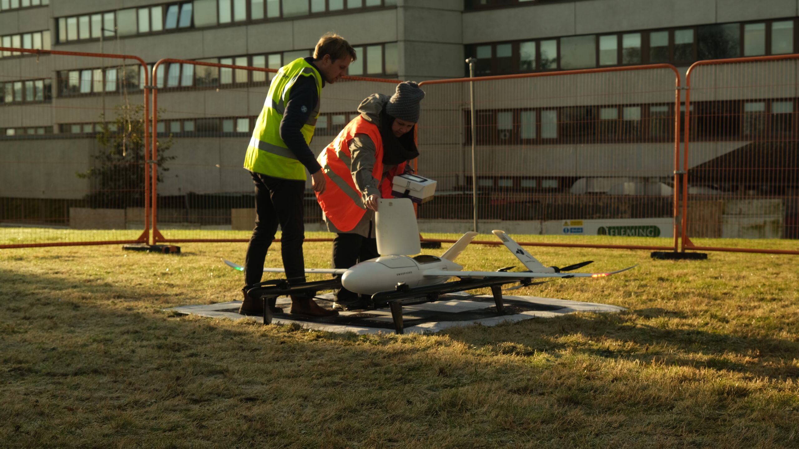 two people standing beside the drone